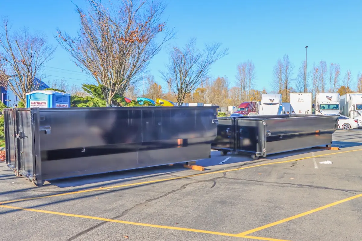 Professional dumpster rental service with roll-off container on residential driveway in Tolleson